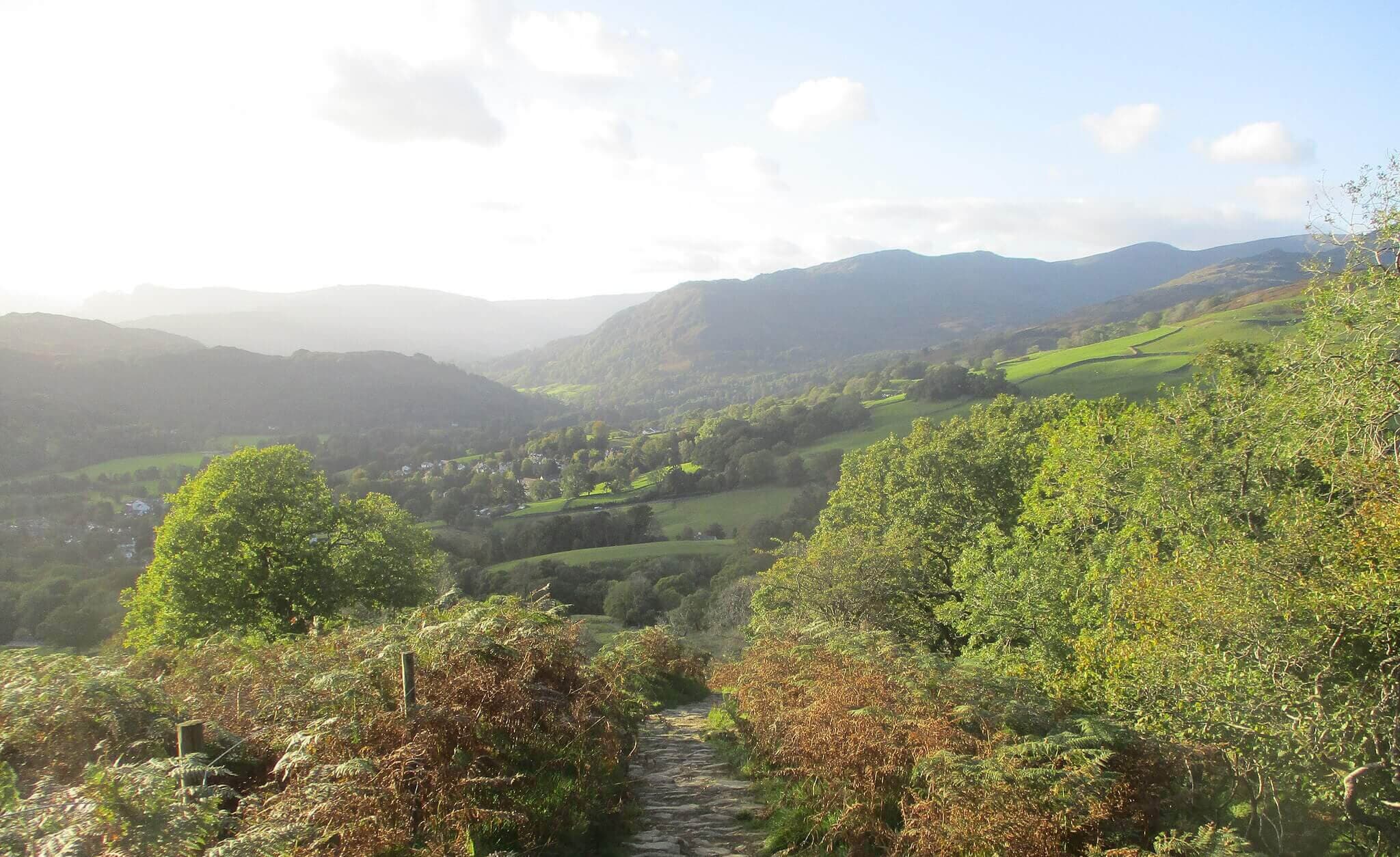 The view from Wansfell Pike with a stone track ahead on a dog friendly walk in the Lake District