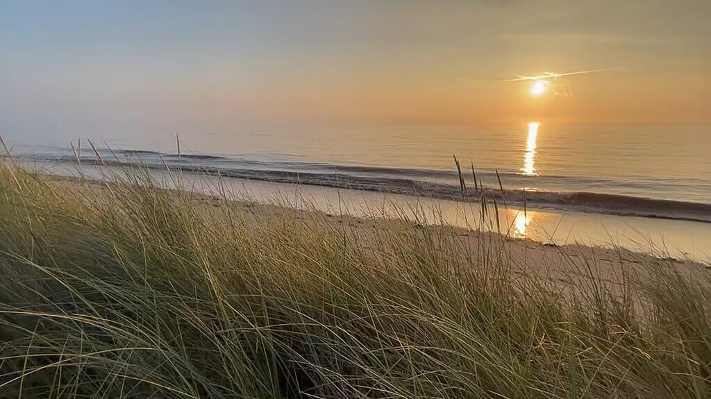 View out to sea fromt he top of the dunes towards sunset on Gibraltar Point dog friendly beach
