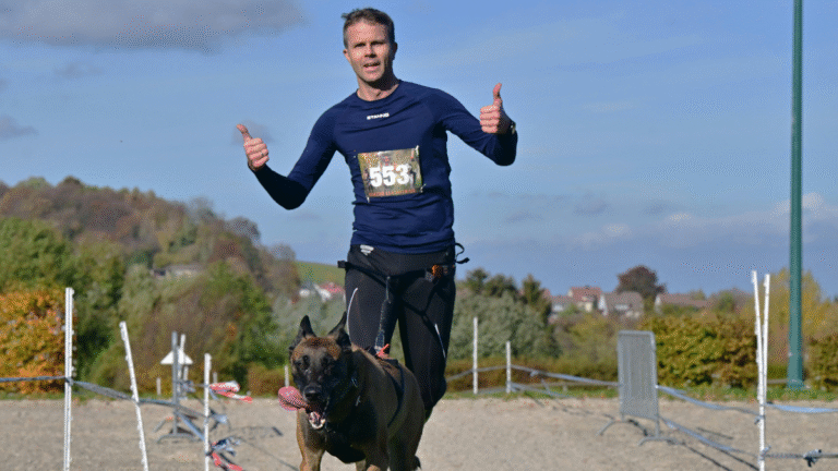 man participates in canicross with his dog